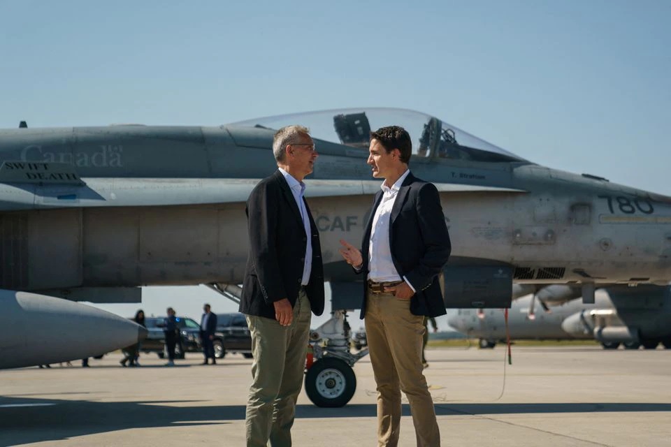 Perdana Menteri Kanada Justin Trudeau berbicara dengan Sekretaris Jenderal NATO Jens Stoltenberg di dekat pesawat tempur Angkatan Udara Kanada CF-18 Hornet selama kunjungan mereka ke CFB Cold Lake di Cold Lake, Alberta, Kanada 26 Agustus 2022. Foto: Adam Scotti/Kantor Perdana Menteri/Handout via Reuters.